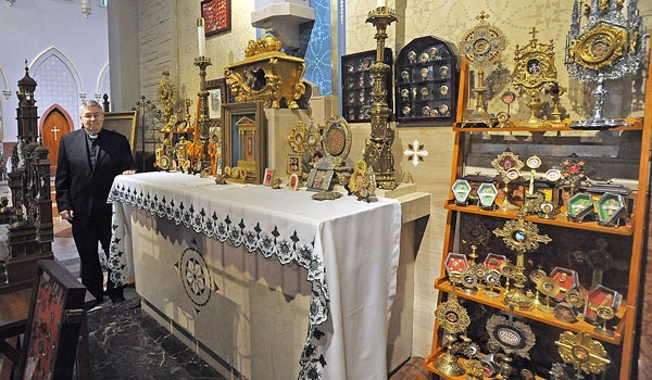 Father Michael Burzynski, pastor of St. John Gualbert, has donated his relic collection to the parish. The 1,100 pieces date from the first century through the 20th century. (Dan Cappellazzo/Staff Photographer)